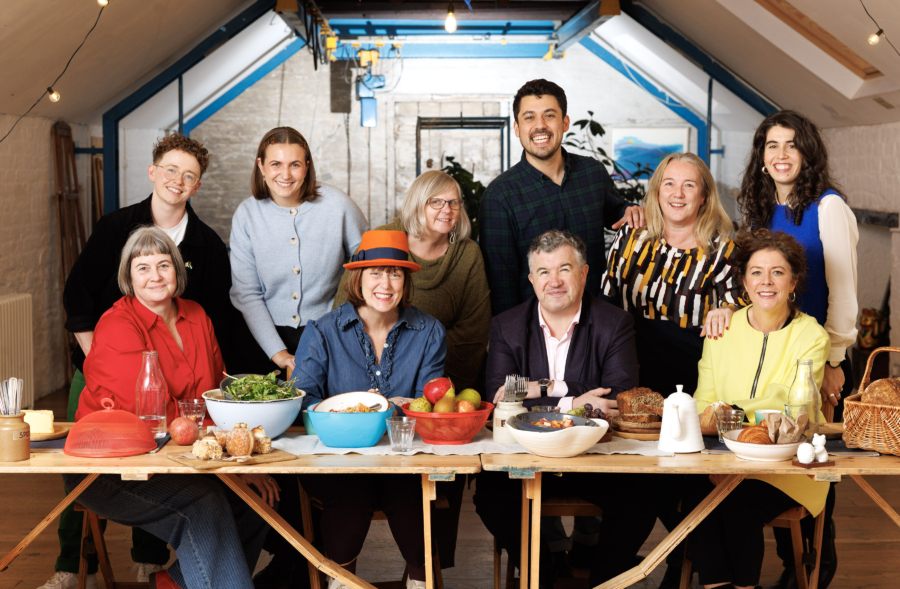 A group of smiling people enjoying a community feast