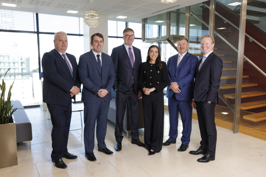 A smiling group of people in business attire