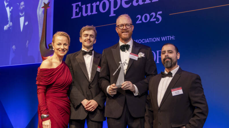 Mid L - R: Matthew Nuding, Associate with Ron Boucher, Partner, Head of London Office accepting the 2025 award.